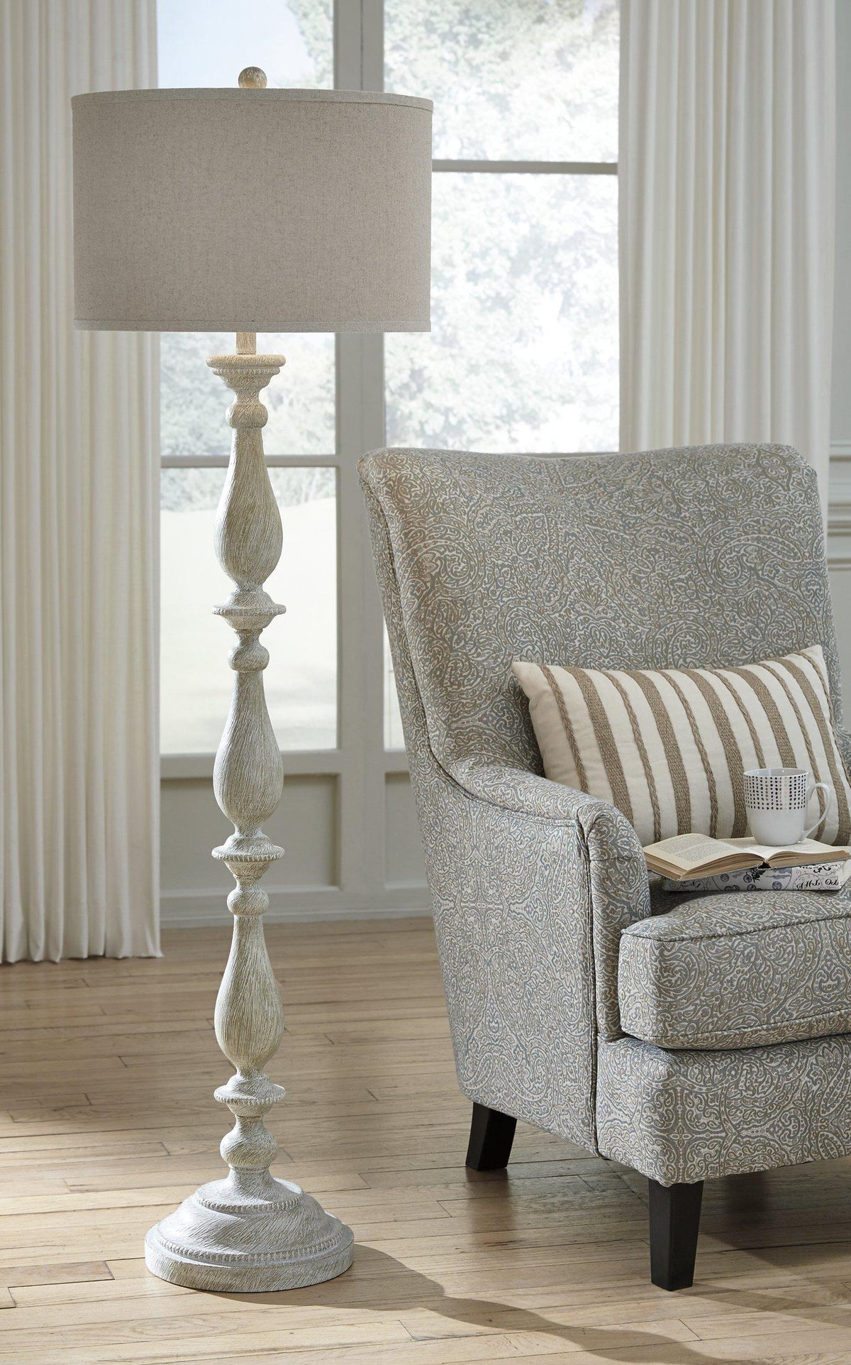Modern Bernadate Floor Lamp by Ashley Furniture featuring a sleek design with a tall metal stand and fabric lampshade.