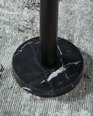 Close-up of the base of the Sorcha floor lamp by Ashley Furniture, showcasing its elegant design and sturdy construction.