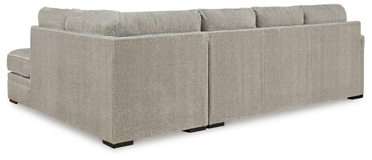 Ashley Furniture Calnita living room set with a sofa and matching armchair in a modern design, shown in a spacious living room.
