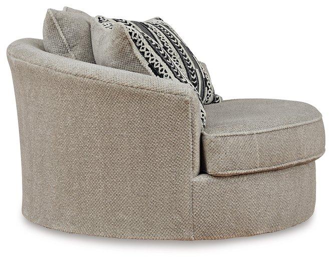 Ashley Furniture Calnita living room set with sofa, loveseat, and armchair in neutral fabric, arranged in a modern living space.