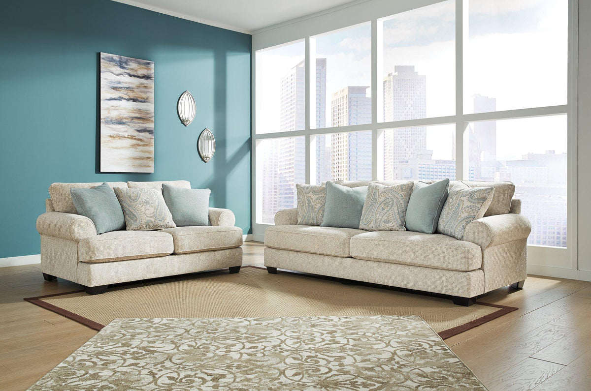 Ashley Furniture Monaghan living room set, includes sofa and loveseat with plush cushions and neutral fabric upholstery.