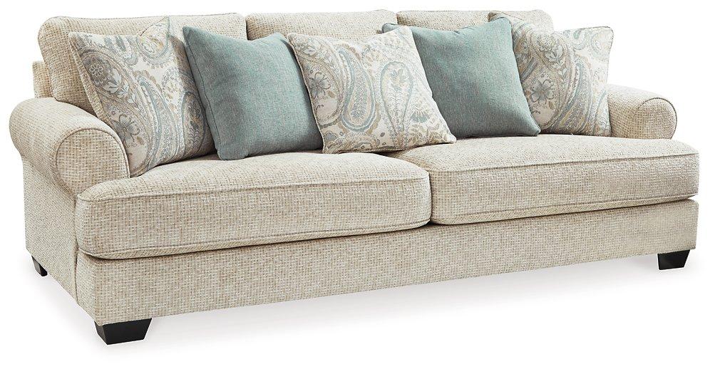 Ashley Furniture Monaghan Living Room Set featuring a plush sofa and matching armchair with neutral fabric upholstery.