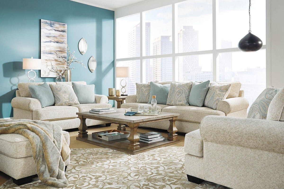 Ashley Furniture Monaghan living room set with a sofa and matching chairs, featuring neutral upholstery and wooden accents.