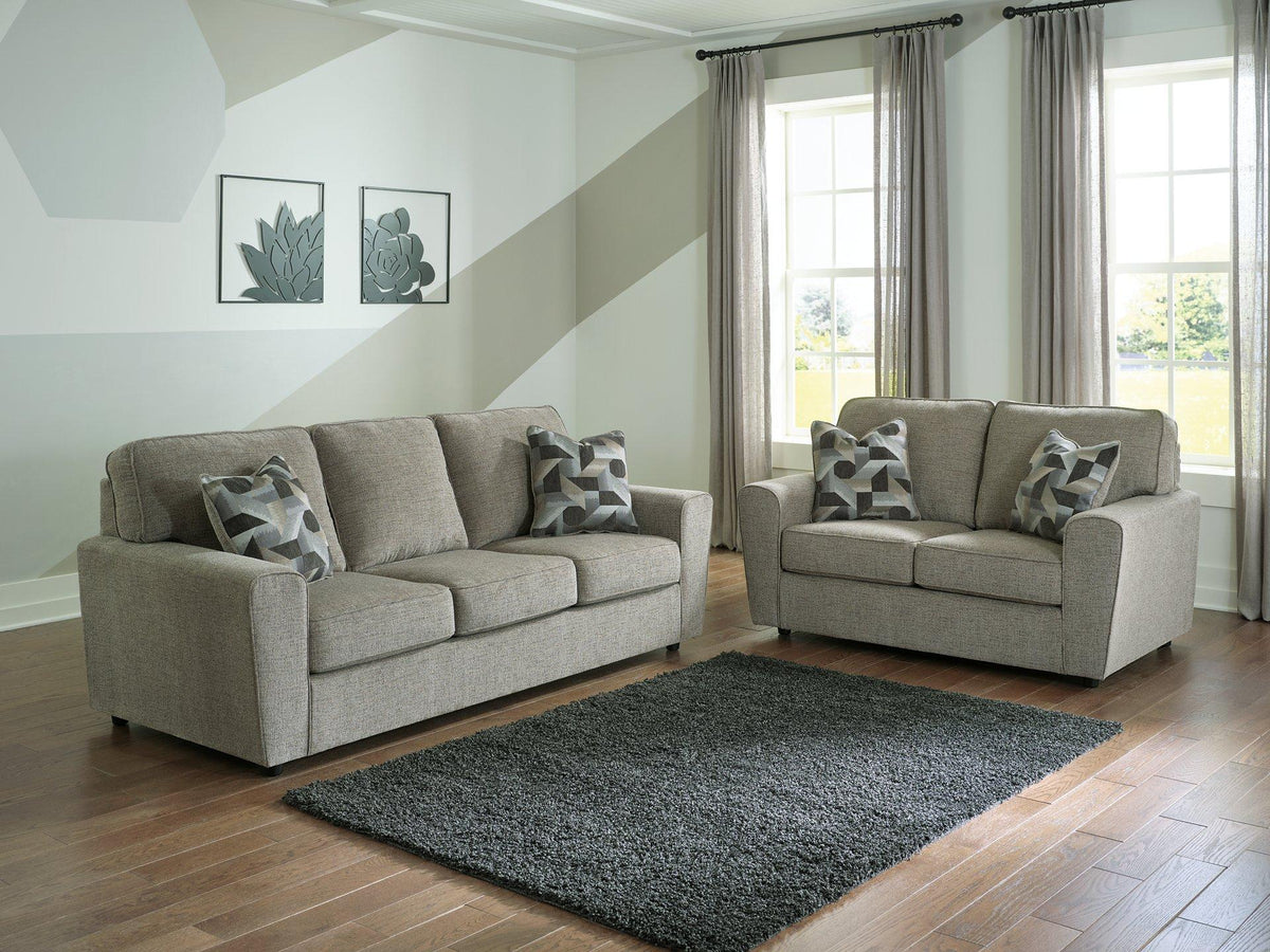 Ashley Furniture Cascilla living room set with sofa and armchair, featuring neutral upholstery and modern design.