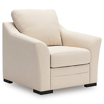 Ashley Furniture Lango Living Room Set showing a sectional sofa with beige upholstery and wooden legs in a modern living space.