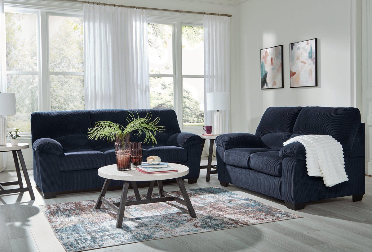 Ashley Furniture SimpleJoy living room set with sofa and armchair in a modern design, featuring neutral upholstery and wooden legs.