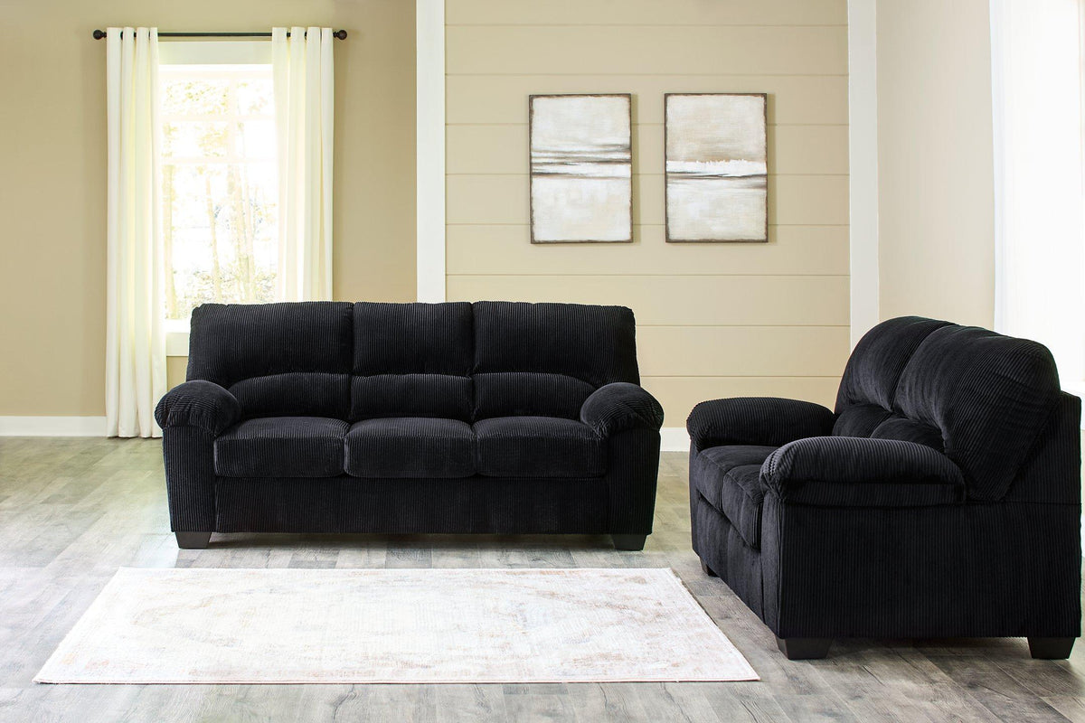 Ashley Furniture SimpleJoy living room set with a sofa and matching armchair, upholstered in neutral fabric with wooden legs.