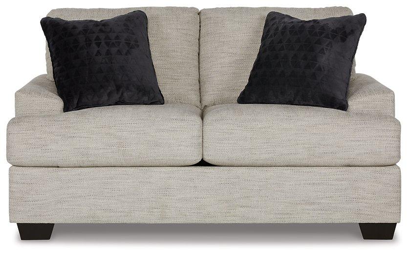 Ashley Furniture Vayda living room set with a sofa and armchair in a modern design, featuring neutral upholstery and wooden legs.