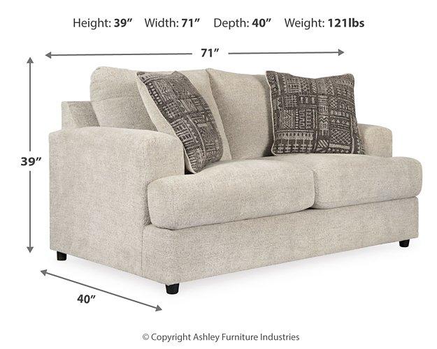 Ashley Furniture Soletren Living Room Set with sofa and armchair featuring neutral upholstery and modern design in a cozy living space.