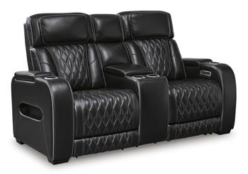 Ashley Furniture Boyington power reclining loveseat with console, showing plush upholstery and built-in cup holders.