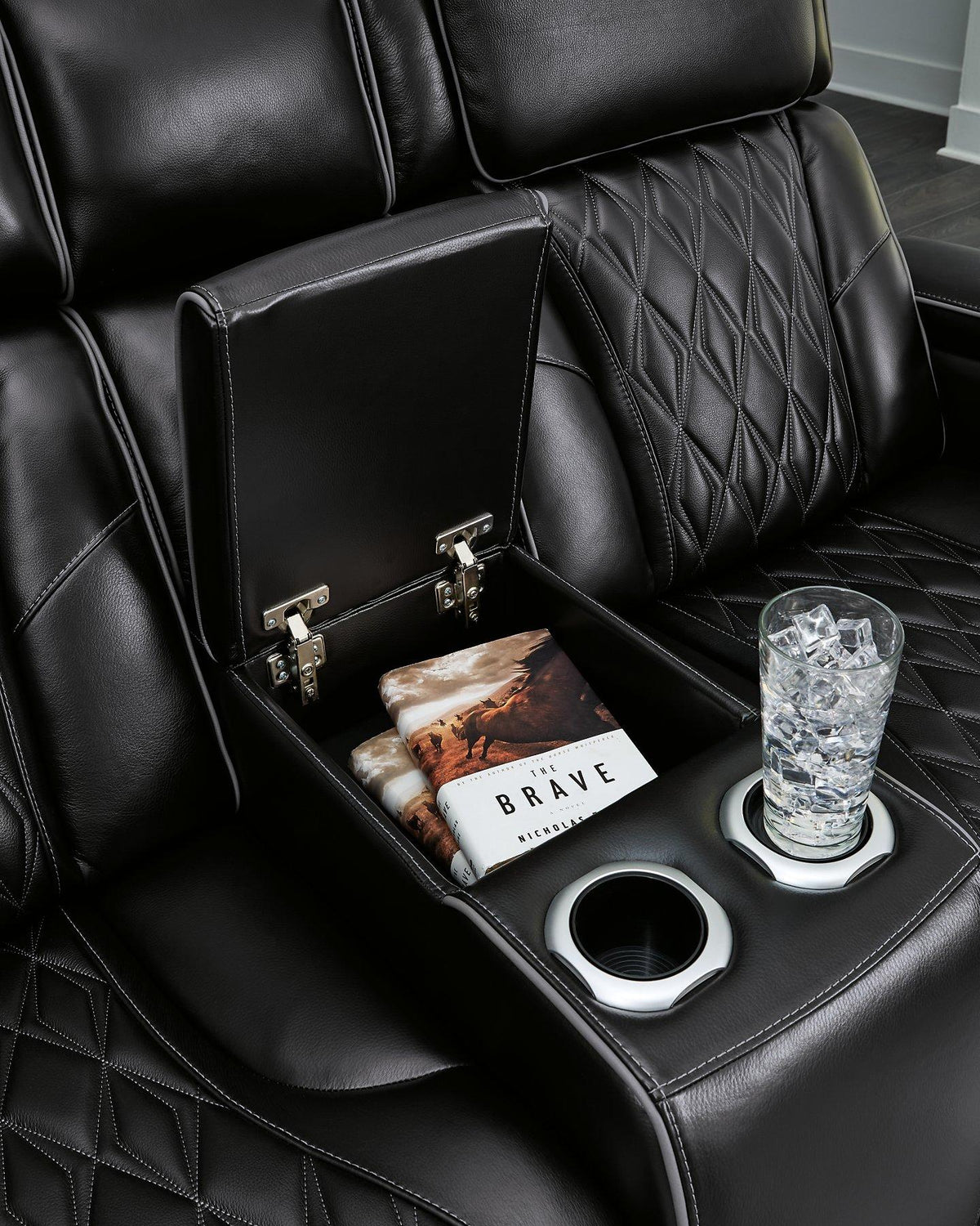 Boyington Power Reclining Loveseat by Ashley Furniture with built-in console, featuring plush cushions and dark upholstery for comfort.