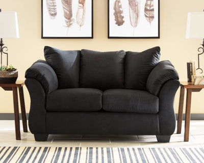 Ashley Furniture Darcy Loveseat with plush fabric and cushioned armrests, ideal for cozy living room seating.
