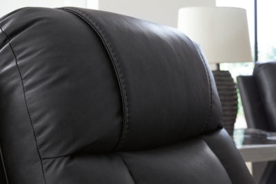 Ashley Furniture Mackmenville reclining loveseat with console, featuring jumbo stitching and plush fabric for comfortable seating.