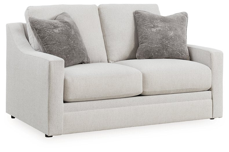 Ashley Furniture Adda loveseat in a cozy fabric with plush cushions, shown from an angled view.