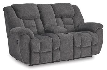 Ashley Furniture reclining loveseat with built-in console, featuring plush upholstery and comfortable armrests.
