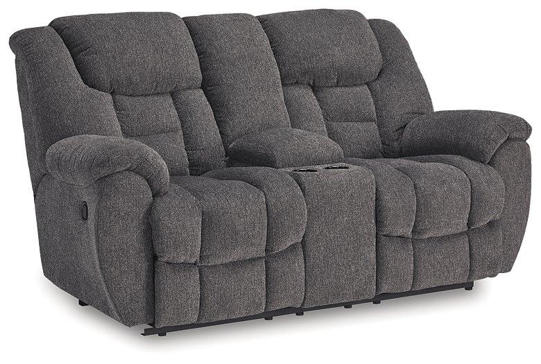 Ashley Furniture reclining loveseat with console, featuring plush upholstery and built-in cup holders for comfort and convenience.