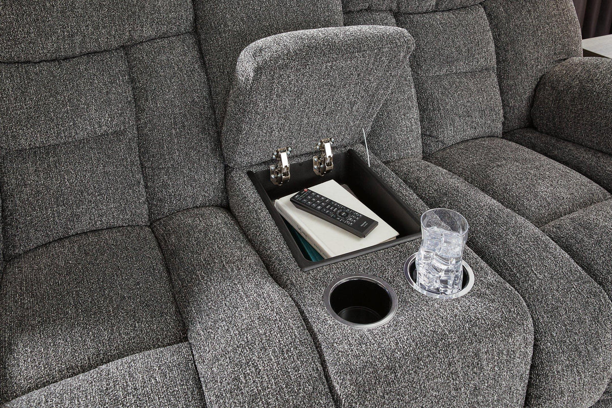 Ashley Furniture reclining loveseat with console, featuring plush cushions and built-in cup holders, perfect for cozy living rooms.