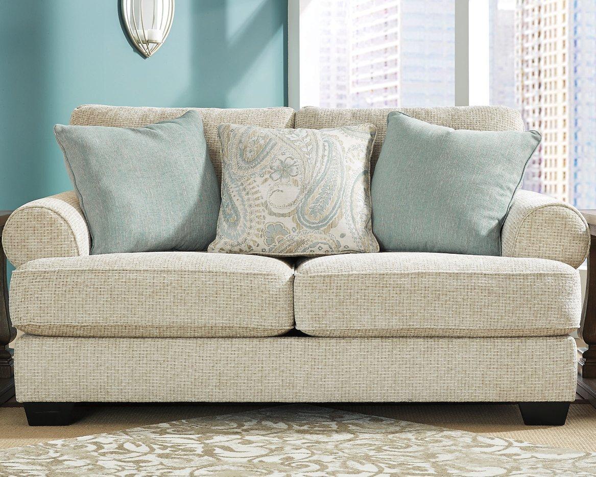 Ashley Monaghan loveseat with plush fabric, featuring wide armrests and a comfortable cushioned seating area.