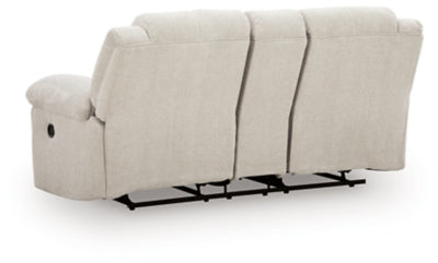 Ashley Furniture Orlen reclining loveseat with console, showing plush fabric, padded armrests, and built-in cup holders in a cozy living room setting.