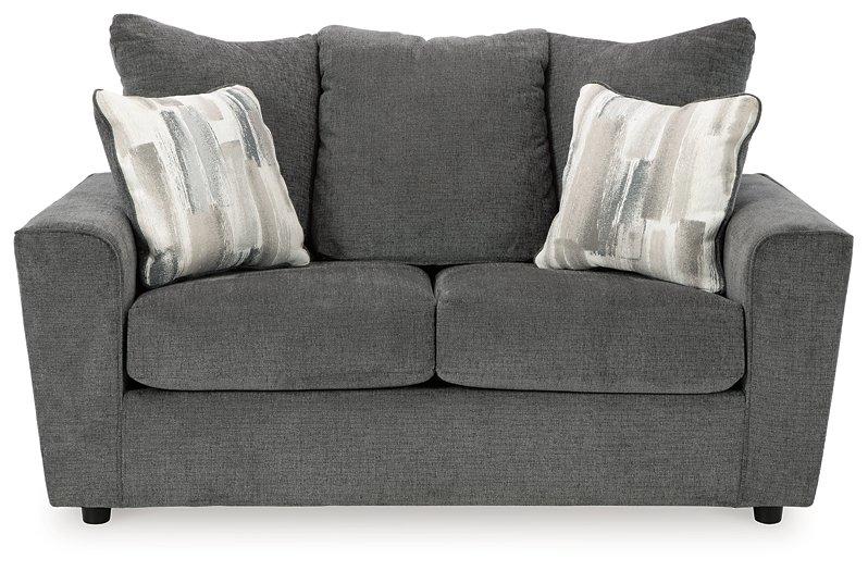 Ashley Furniture Stairatt loveseat showing plush fabric upholstery and cushioned backrest in a cozy living room setting.
