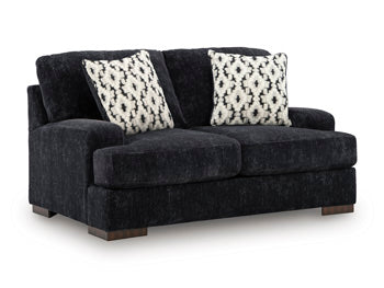 Ashley Furniture Whitmore Manor loveseat with plush fabric and elegant design, shown from an angled view.