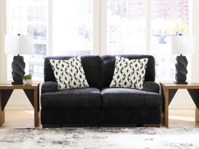 Ashley Furniture Whitmore Manor loveseat with plush fabric, featuring cushioned arms and a cozy, inviting design.