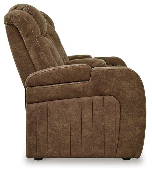 Ashley Furniture Wolfridge power reclining loveseat with plush fabric and built-in recline mechanism, ideal for comfort and relaxation.