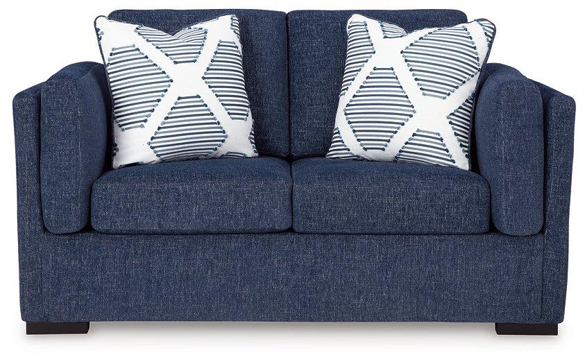 Ashley Furniture Evansley loveseat with plush fabric and cushioned arms, perfect for cozy living room seating.