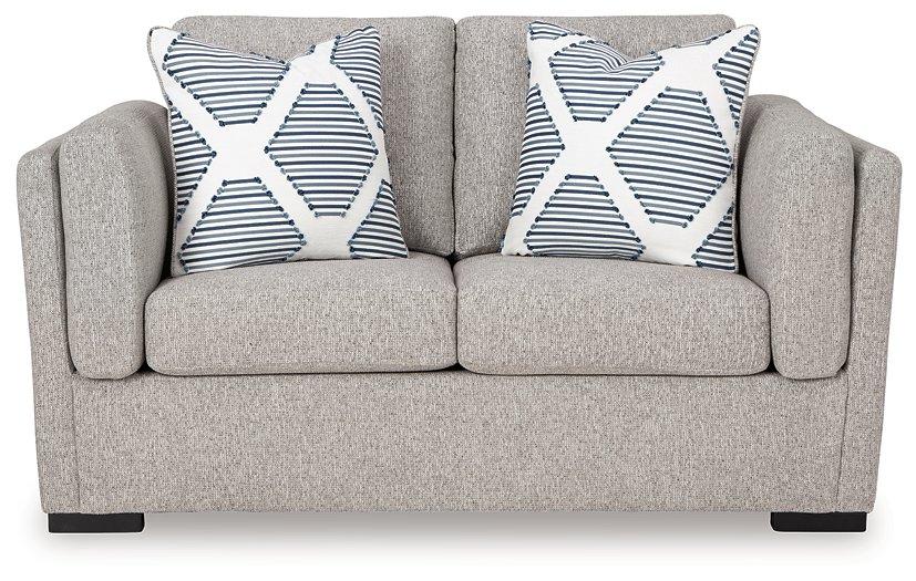 Ashley Furniture Evansley loveseat with plush fabric, cushioned back and armrests, in a cozy, stylish living room setting.