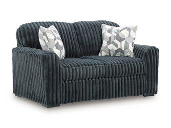 Ashley Furniture Midnight-Madness loveseat with plush fabric and modern design, shown from an angled view.