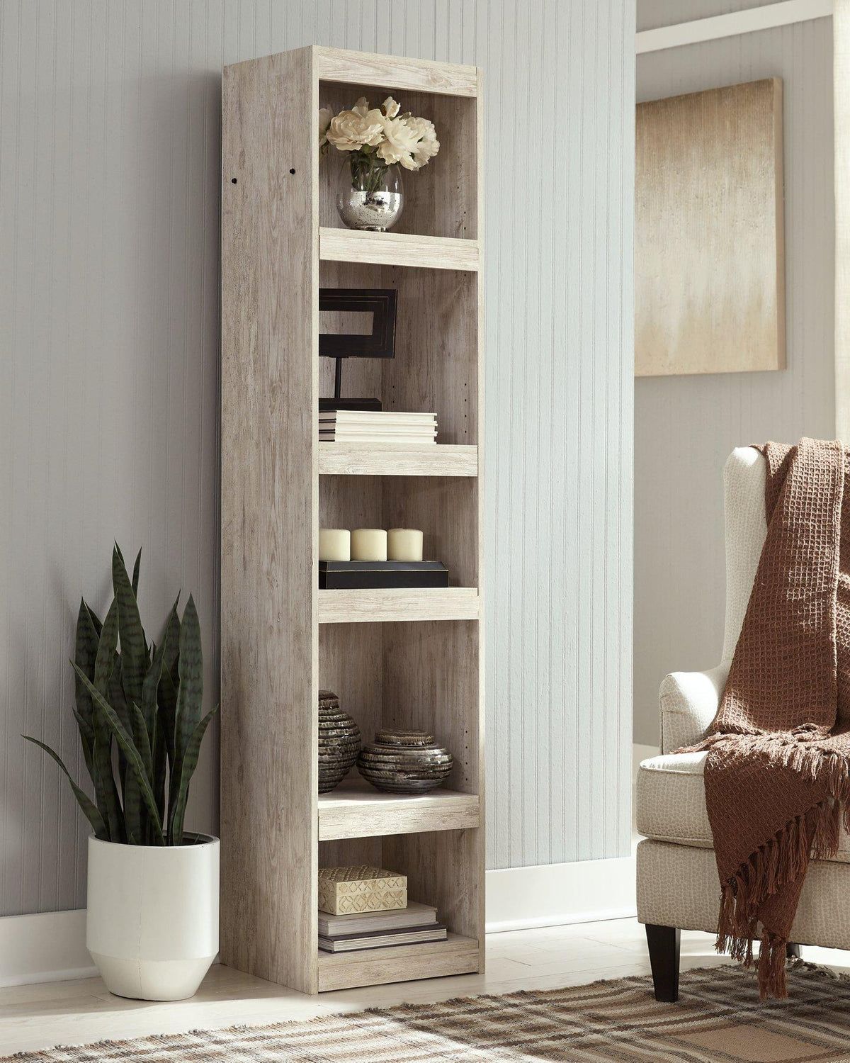 Ashley Furniture Willowton Pier media tower with open shelves and storage compartments, showcasing a modern design.