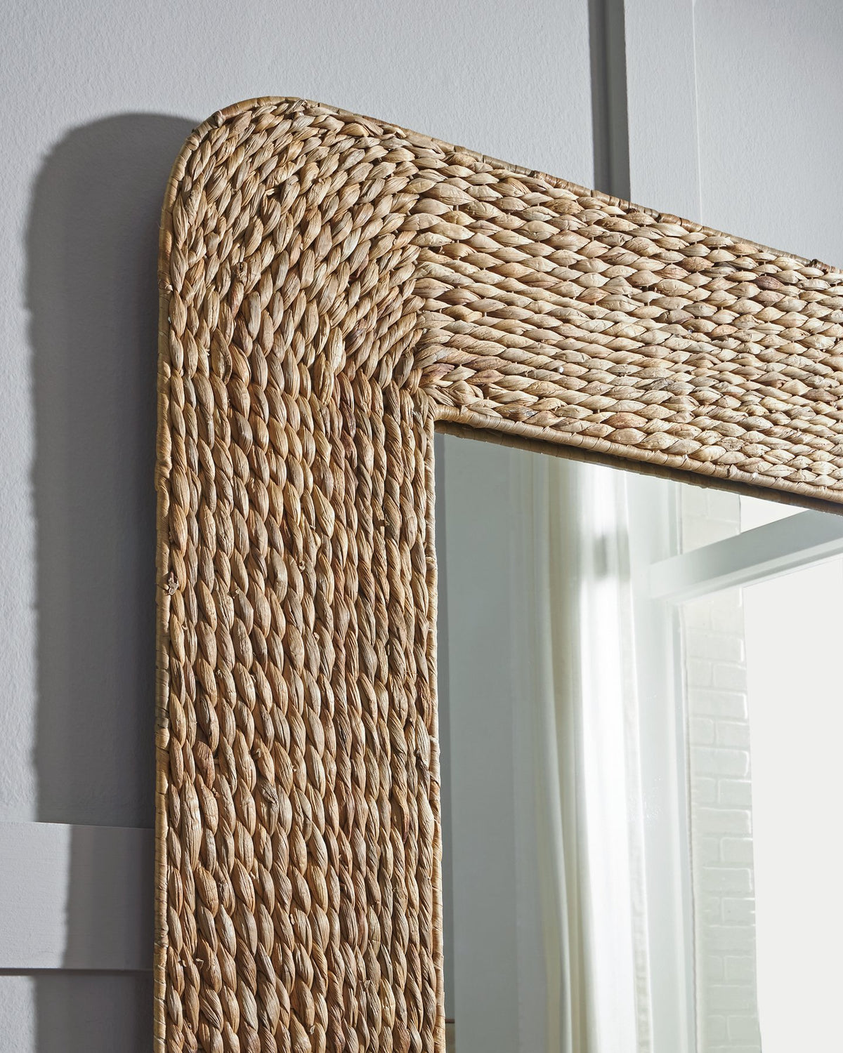 Ashley Furniture Norigan floor mirror with a sleek, full-length glass surface and modern frame for stylish home decor.