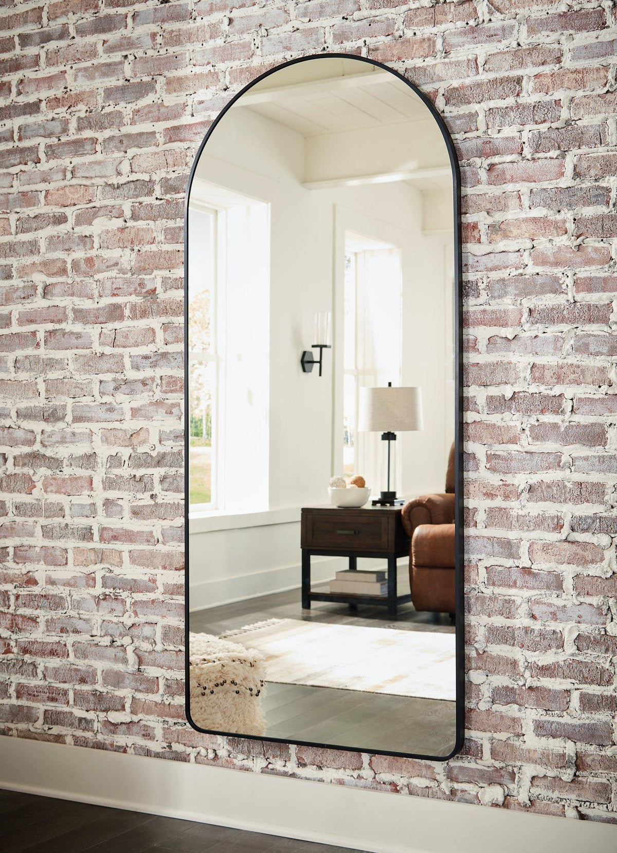 Full-length Ashley Furniture Sethall floor mirror with a sleek frame, standing upright in a modern room setting.