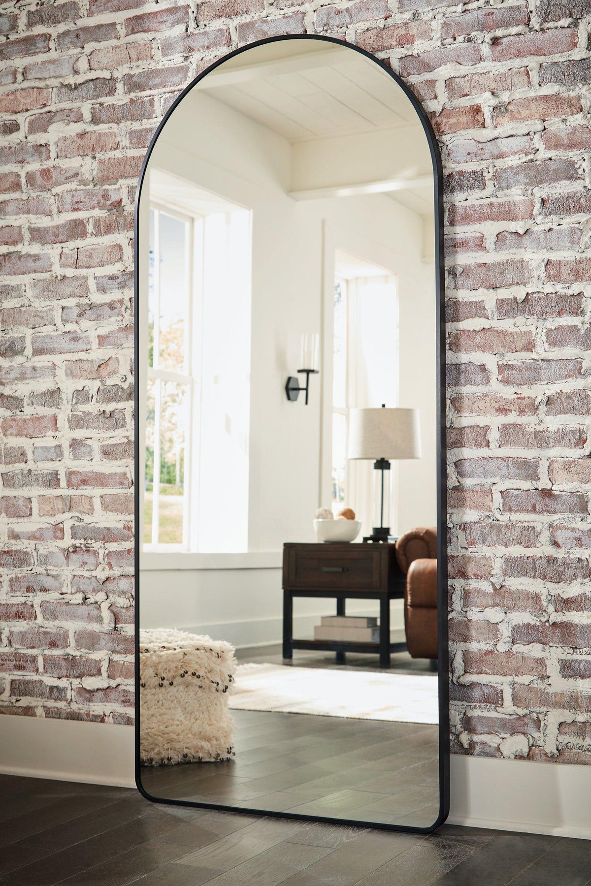 Full-length Ashley Furniture Sethall floor mirror with a sleek wooden frame, standing upright in a modern room setting.