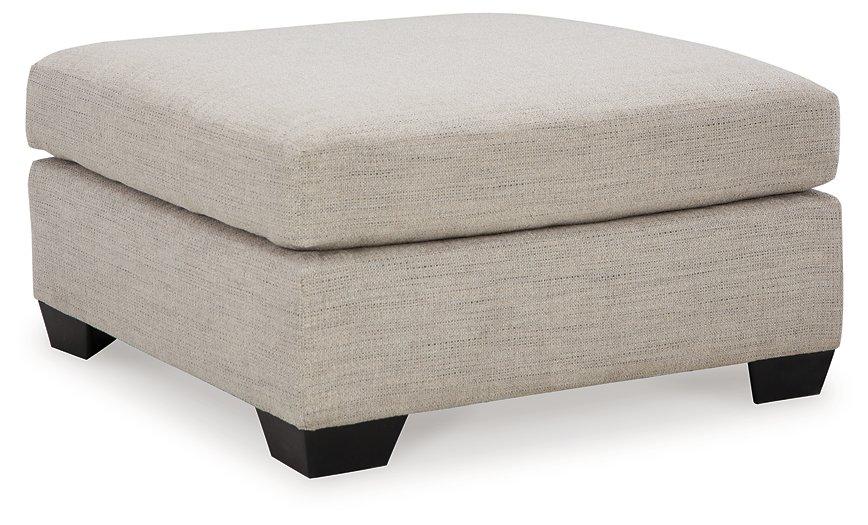 Mahoney oversized accent ottoman by Ashley Furniture with plush fabric and modern design in a cozy living room setting.