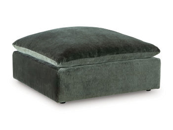 Ashley Furniture Carriage View oversized accent ottoman with tufted fabric and wooden legs, shown from an angle.