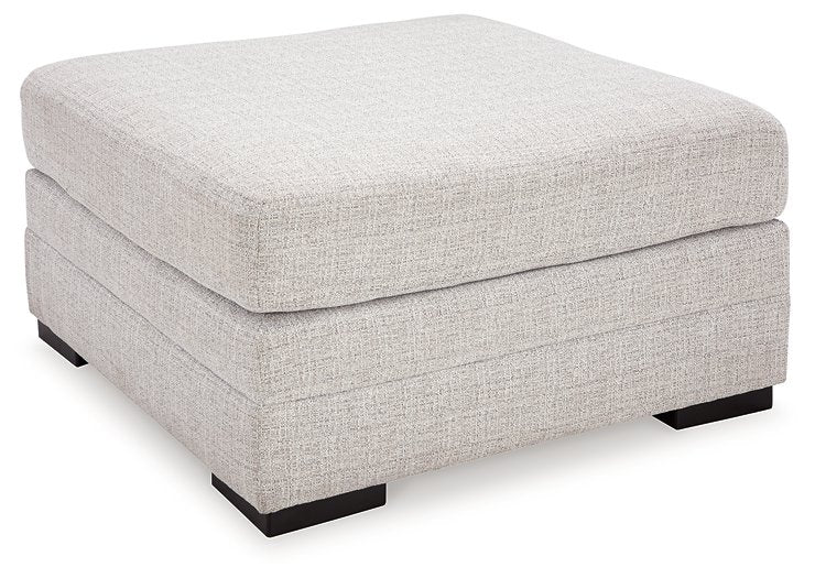 Ashley Furniture Koralynn oversized accent ottoman with a soft fabric cover and plush cushioning, shown from an angled side view.