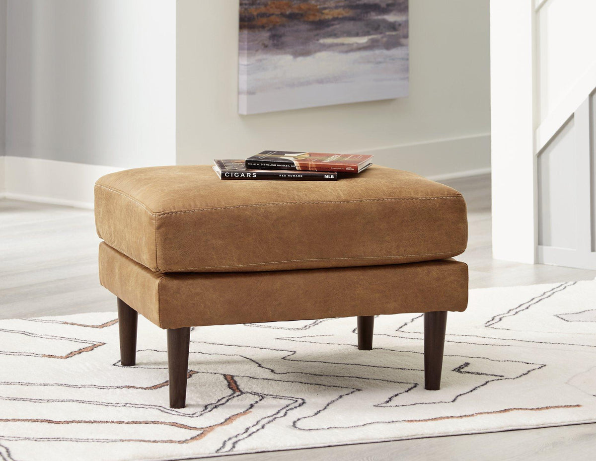 Ashley Furniture Telora Ottoman with plush fabric and wooden legs, showcasing its stylish and comfortable design.