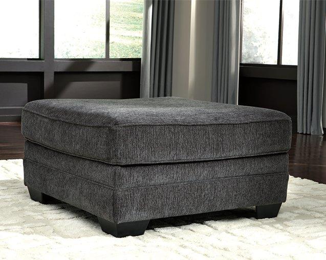 Oversized Ashley Furniture Tracling Ottoman with soft fabric upholstery and plush cushioning on a modern living room floor.