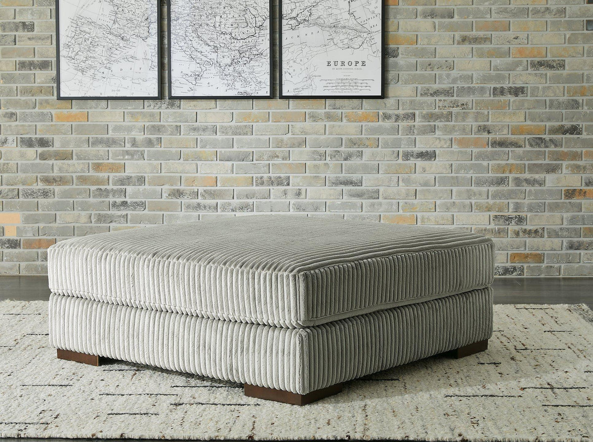 Lindyn oversized accent ottoman by Ashley Furniture with plush fabric and modern design, placed in a stylish living room setting.