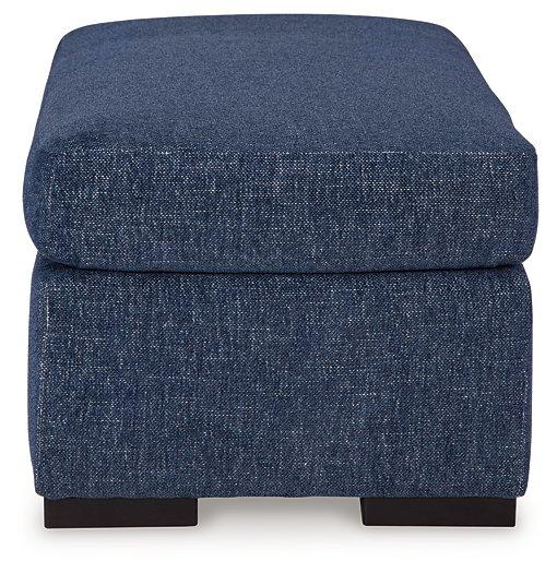 Ashley Furniture Evansley Ottoman with plush fabric and wooden legs, perfect for living room decor and added seating.