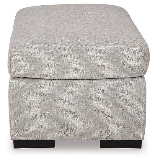 Ashley Furniture Evansley Ottoman with cushioned top and wooden legs, showcasing a stylish and versatile accent piece.