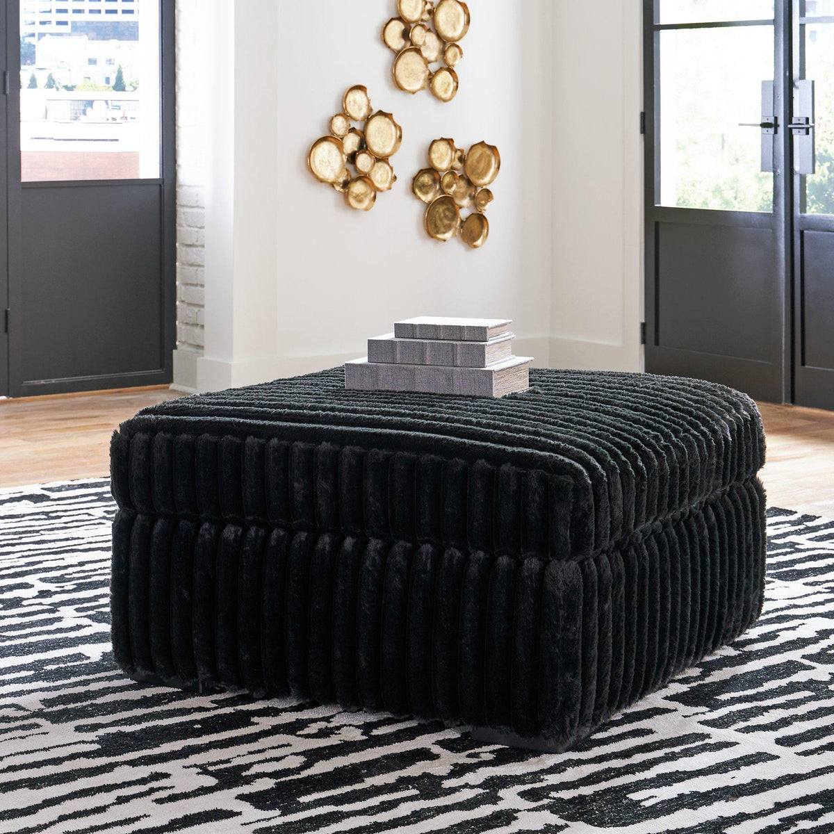 Oversized Midnight-Madness Ashley Furniture accent ottoman with plush fabric and modern design, shown in a cozy living room setting.