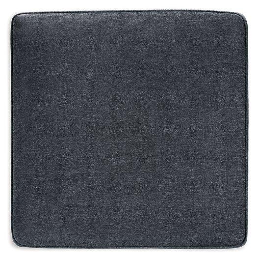 Oversized Ashley Furniture Altari accent ottoman with plush fabric and sturdy wooden legs sitting on a neutral-toned floor.
