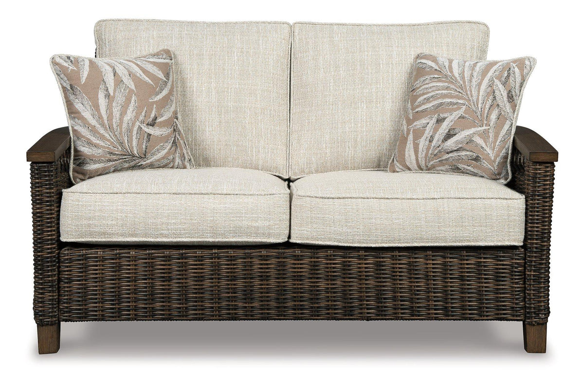 Outdoor loveseat by Ashley Furniture featuring cushioned seating and a sturdy metal frame for patio relaxation.