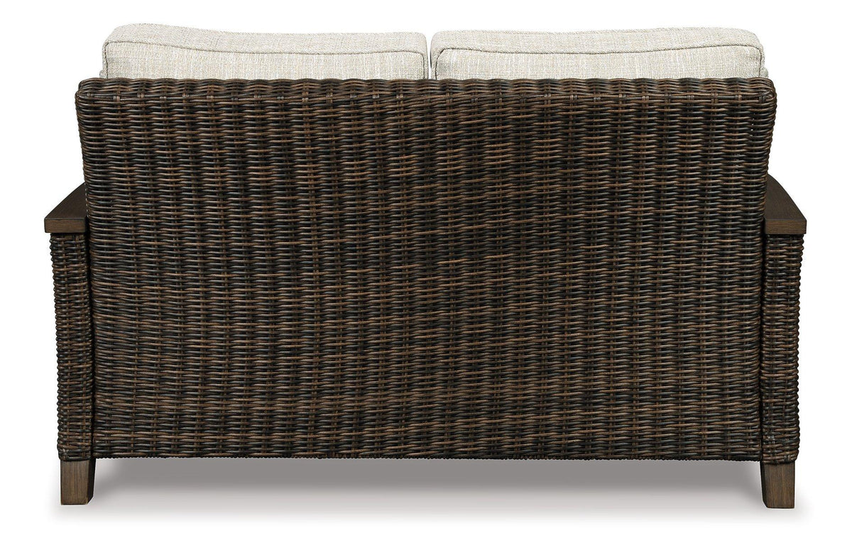 Outdoor loveseat by Ashley Furniture with plush cushions and durable frame, perfect for outdoor patio seating.