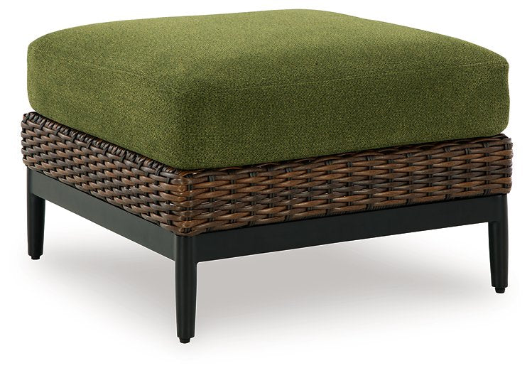 Outdoor ottoman with cushion from Ashley Furniture's Horizon Hall collection, shown from an angled side view.