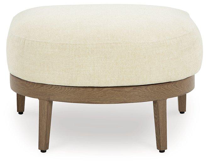 Outdoor Ashley Furniture Serene Bay Ottoman with cushion, featuring woven design and plush seating for outdoor relaxation.
