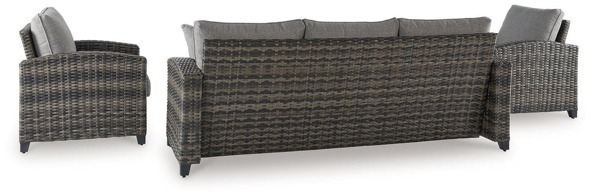 Outdoor seating set by Ashley Furniture with sofa, chairs, and table for patio or garden use.