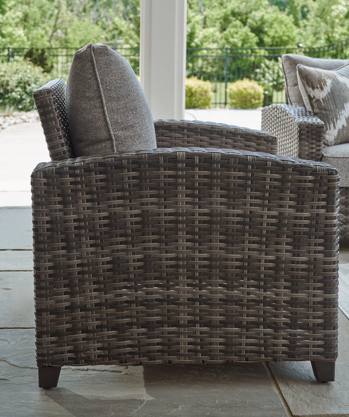 Outdoor Oasis Court furniture set with sofa, chairs, and table by Ashley Furniture, featuring stylish outdoor seating and table arrangement.
